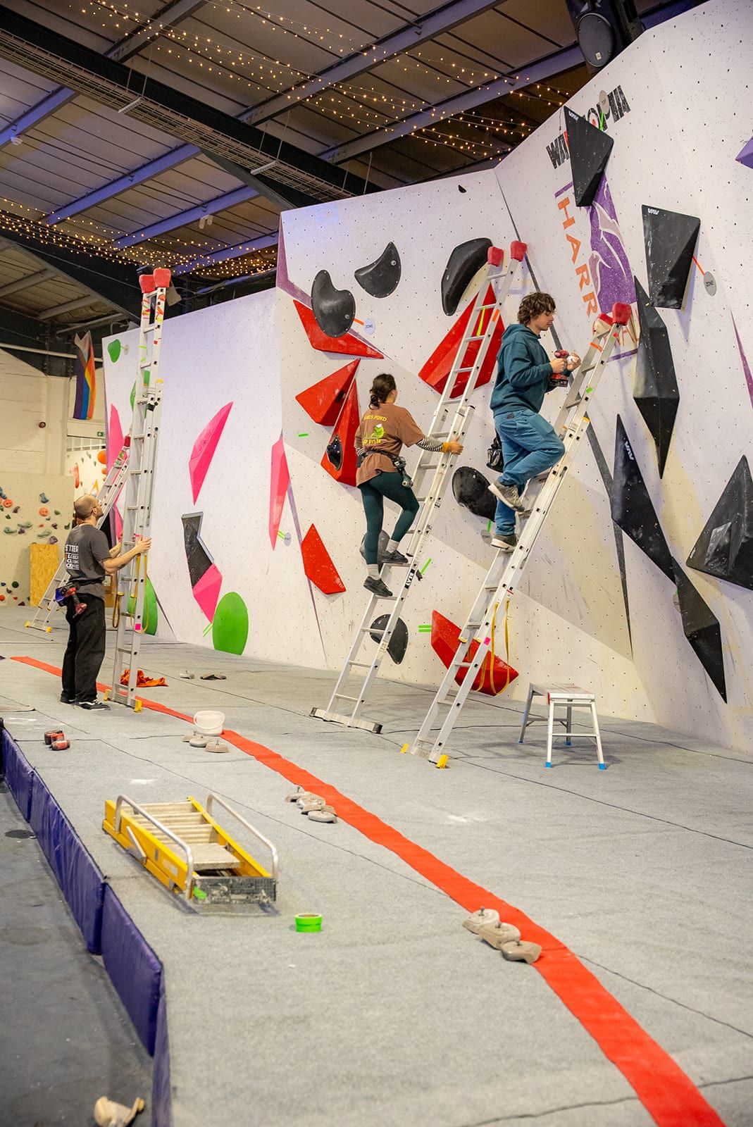 Setters on ladders working on the HarroWall comp wall